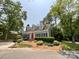 Well-maintained single-Gathering home with dormer windows, manicured landscaping, and a vibrant red front door at 2619 Quailrush Rd, Charlotte, NC 28226