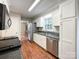 A large kitchen featuring stainless steel appliances and bright white cabinetry at 2619 Quailrush Rd, Charlotte, NC 28226
