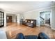 Open-concept living room with hardwood floors, neutral walls, and seamless flow to other living spaces at 2619 Quailrush Rd, Charlotte, NC 28226