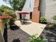 Outdoor patio with furniture, umbrella and brick fireplace, perfect for relaxing and entertaining at 2619 Quailrush Rd, Charlotte, NC 28226