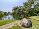 Scenic pond with a water fountain, walking trail, and lush landscaping for a peaceful atmosphere at 2619 Quailrush Rd, Charlotte, NC 28226
