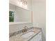 This bathroom features a granite-topped sink with a large mirror and vanity lighting at 2666 Providence Dr, Gastonia, NC 28052
