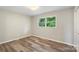 Bedroom featuring hardwood floors and a bright window for natural light at 2666 Providence Dr, Gastonia, NC 28052