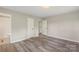 Clean bedroom featuring wood floors, a closet, and ensuite access at 2666 Providence Dr, Gastonia, NC 28052