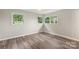Bright bedroom with hardwood floors and natural light streaming through multiple windows at 2666 Providence Dr, Gastonia, NC 28052