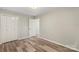 This bedroom features neutral walls, wood-look flooring, and a closet at 2666 Providence Dr, Gastonia, NC 28052