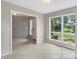Bright living room with tile floors and large windows overlooking a well-maintained front yard at 2666 Providence Dr, Gastonia, NC 28052
