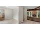 Inviting living area with a stone fireplace, tiled floors, and natural light, seamlessly connected to the kitchen at 2666 Providence Dr, Gastonia, NC 28052