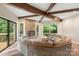 Cozy living room with stone fireplace, wood beam ceiling, and slider to deck at 2666 Providence Dr, Gastonia, NC 28052