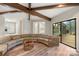 Spacious living room with beamed ceilings, wood floors, and access to the deck at 2666 Providence Dr, Gastonia, NC 28052
