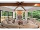 Open-concept living room with a stone fireplace and wall-to-wall windows at 2666 Providence Dr, Gastonia, NC 28052