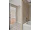 Modern bathroom with a bathtub featuring ceramic tile, chrome fixtures, and a view into another room at 300 W 5Th St # 812, Charlotte, NC 28202