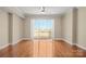 Bright bedroom featuring hardwood floors, a ceiling fan, and access to a private balcony at 300 W 5Th St # 812, Charlotte, NC 28202
