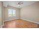 Bright, sunny bedroom with neutral walls, wood floors, and a large window providing natural light at 300 W 5Th St # 812, Charlotte, NC 28202