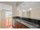 Kitchen bar features granite countertops with stainless steel appliances and a view to balcony at 300 W 5Th St # 812, Charlotte, NC 28202