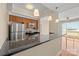 Kitchen bar overlooks living room and balcony with stainless appliances and granite counters at 300 W 5Th St # 812, Charlotte, NC 28202