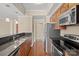View of kitchen with stainless appliances, granite countertops, and a breakfast bar sink at 300 W 5Th St # 812, Charlotte, NC 28202