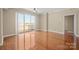 Spacious living room with laminated floor, ceiling fan, and sliding doors to a balcony at 300 W 5Th St # 812, Charlotte, NC 28202