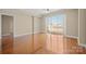 Spacious living room with laminated floor, ceiling fan, and sliding doors to a balcony at 300 W 5Th St # 812, Charlotte, NC 28202