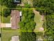 Aerial view of the property featuring the roof, large backyard, and surrounding trees at 303 Jean Ave, Kannapolis, NC 28083
