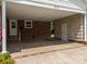 Covered carport with brick and shingle siding, two entrances and concrete floor at 303 Jean Ave, Kannapolis, NC 28083