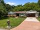 Charming single-story home with a brick driveway, manicured lawn, and traditional landscaping at 303 Jean Ave, Kannapolis, NC 28083