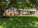 A well-maintained home with brick facade, neat landscaping, and shaded front yard at 303 Jean Ave, Kannapolis, NC 28083