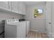 Convenient laundry room with a window for natural light and a white washer and dryer at 303 Jean Ave, Kannapolis, NC 28083