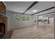 Bright living room with a fireplace, wood floors, beamed ceilings and an open floor plan at 303 Jean Ave, Kannapolis, NC 28083