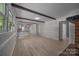 Bright living room with wood floors, neutral paint, beamed ceilings, and a view to another room at 303 Jean Ave, Kannapolis, NC 28083