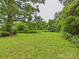 Spacious backyard featuring lush green grass and mature trees, perfect for outdoor activities at 3055 16Th Ne St, Hickory, NC 28601