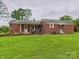 Brick home featuring an open backyard and a covered patio area great for entertainment at 3055 16Th Ne St, Hickory, NC 28601