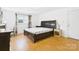 Bedroom featuring a dark wood sleigh bed and wood-look flooring at 3055 16Th Ne St, Hickory, NC 28601