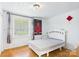 Cozy bedroom with light-colored paneling and window with blinds at 3055 16Th Ne St, Hickory, NC 28601