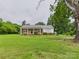 Charming brick and white home featuring a covered porch and expansive front yard at 3055 16Th Ne St, Hickory, NC 28601