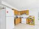 Functional kitchen featuring wood cabinets, white appliances, and tiled floors at 3055 16Th Ne St, Hickory, NC 28601