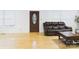 Bright living room with hardwood floors, large windows and dark leather furniture at 3055 16Th Ne St, Hickory, NC 28601