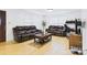 A bright living room with hardwood floors, multiple windows, and dark furniture at 3055 16Th Ne St, Hickory, NC 28601
