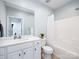 Clean bathroom with a single sink vanity, large mirror, and shower-tub combo exudes simplicity and functionality at 3248 Margellina Dr, Charlotte, NC 28210