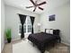 Cozy bedroom features a ceiling fan, plush carpeting, and a window with black-out curtains for a relaxing ambiance at 3248 Margellina Dr, Charlotte, NC 28210