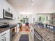 Galley kitchen with granite countertops, stainless steel appliances, and bright lighting at 3248 Margellina Dr, Charlotte, NC 28210
