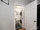 Convenient laundry room featuring stacked washer and dryer units to maximize space, and built in shelving at 3248 Margellina Dr, Charlotte, NC 28210