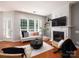 Bright living room featuring a fireplace, large windows, and modern furnishings at 3248 Margellina Dr, Charlotte, NC 28210