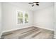 Bright bedroom with gray flooring, white walls, and a ceiling fan at 330 Central Ave, Kannapolis, NC 28081