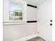 Bright entryway features new wood-look flooring, coat hooks and a window providing natural light at 330 Central Ave, Kannapolis, NC 28081