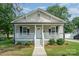 Charming home with a covered front porch, decorative railings, and flower baskets at 330 Central Ave, Kannapolis, NC 28081