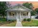 Charming home with a covered front porch, decorative railings, and flower baskets at 330 Central Ave, Kannapolis, NC 28081