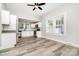 Updated kitchen with ample sunlight, stainless steel appliances, and new wood-look floors at 330 Central Ave, Kannapolis, NC 28081