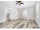 Spacious living room with new wood-look flooring, neutral paint, and a ceiling fan at 330 Central Ave, Kannapolis, NC 28081
