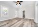 Open floorplan with updated wood-look floors, large windows, and freshly painted walls at 330 Central Ave, Kannapolis, NC 28081